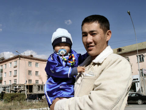CLICK ON PHOTO FOR ENLARGEMENT - Man and baby